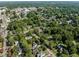 Enjoy an aerial view highlighting the neighborhood's tree-lined streets, nearby water tower, and a glimpse of community living at 412 Coggeshall St, Oxford, NC 27565