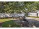 Charming backyard featuring a patio with seating, lush green grass, and a white fence for privacy at 412 Coggeshall St, Oxford, NC 27565