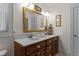 Bright bathroom featuring a dual sink vanity, framed mirror, and decorative fixtures for a classic design at 412 Coggeshall St, Oxford, NC 27565