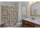 Neat bathroom with tub-shower, classic toile shower curtain, and vanity with stylish faucet at 412 Coggeshall St, Oxford, NC 27565