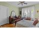 Bedroom with a vintage dressing table with mirror, ceiling fan, and lacy bedspread at 412 Coggeshall St, Oxford, NC 27565