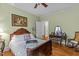 Comfortable bedroom featuring a wood-framed bed, hardwood floors, and vintage furnishings for a welcoming space at 412 Coggeshall St, Oxford, NC 27565