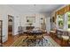 Well-lit dining area with hardwood floors, a chandelier, and access to the kitchen at 412 Coggeshall St, Oxford, NC 27565