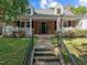 Charming brick home with a welcoming front porch, dormer windows, and well-maintained landscaping for enhanced curb appeal at 412 Coggeshall St, Oxford, NC 27565