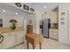 Kitchen with stainless steel refrigerator, tile floors, and butcher block island at 412 Coggeshall St, Oxford, NC 27565