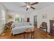Cozy living room with hardwood floors, a ceiling fan, and a comfortable sofa near sunlit windows at 412 Coggeshall St, Oxford, NC 27565