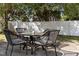 Outdoor patio area features a round table and comfortable woven chairs under the shade of mature trees at 412 Coggeshall St, Oxford, NC 27565