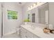 Bright bathroom featuring white vanity, a large mirror, and plenty of natural light at 4151 Deep Wood Cir, Durham, NC 27707