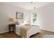 Cozy bedroom featuring wood floors, neutral paint, and a plush white comforter set at 4151 Deep Wood Cir, Durham, NC 27707
