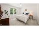 Airy bedroom with a metal frame bed, plush carpet, and a charming peace sign wall decoration at 4151 Deep Wood Cir, Durham, NC 27707