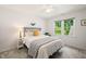 A well-lit bedroom features a metal frame bed and plush carpeting for a cozy feel at 4151 Deep Wood Cir, Durham, NC 27707