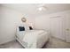 Comfortable bedroom showcasing plush carpeting and a metal-framed bed with white bedding at 4151 Deep Wood Cir, Durham, NC 27707
