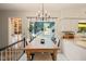 Bright dining area with a view of the deck, featuring a wooden table and an elegant chandelier at 4151 Deep Wood Cir, Durham, NC 27707