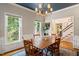 Dining room with wood table and chairs, chandelier, wainscoting, and ample natural light at 4151 Deep Wood Cir, Durham, NC 27707
