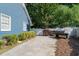 Features driveway, a wood pile behind a white gate and a vintage BBQ grill at 4151 Deep Wood Cir, Durham, NC 27707