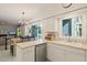 Open kitchen with stainless steel dishwasher and view into the dining room at 4151 Deep Wood Cir, Durham, NC 27707