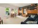 Bright living room with large windows, custom shelves, and comfortable seating at 4151 Deep Wood Cir, Durham, NC 27707