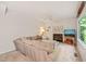 Comfortable living room with a cozy fireplace, large sectional, and view of the lush outdoors at 4151 Deep Wood Cir, Durham, NC 27707
