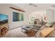 Open-concept living room showcasing a fireplace, sectional sofa, and views into the kitchen at 4151 Deep Wood Cir, Durham, NC 27707