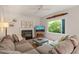 Bright living room featuring fireplace, decorative propeller, fan, and a large window for natural light at 4151 Deep Wood Cir, Durham, NC 27707