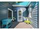 Cozy covered porch with blue siding, cool blue shade cover, plants and a convenient beverage cooler at 4151 Deep Wood Cir, Durham, NC 27707