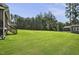 Expansive backyard featuring a large lawn area, mature trees, and partial fencing at 465 Gianna Dr, Clayton, NC 27527