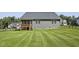 Large, fenced backyard featuring a well-maintained lawn, and a wooden porch at 465 Gianna Dr, Clayton, NC 27527