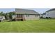 Large, fenced backyard featuring a well-maintained lawn, and a wooden porch at 465 Gianna Dr, Clayton, NC 27527