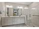 Bright bathroom showcasing double vanity with white cabinetry, subway tile shower and modern fixtures at 465 Gianna Dr, Clayton, NC 27527