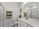 Bright bathroom featuring a white vanity with a marble countertop and a shower with glass doors at 465 Gianna Dr, Clayton, NC 27527