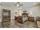 Well-lit bedroom with a bed, armoire, and bathroom access, creating a relaxing retreat at 465 Gianna Dr, Clayton, NC 27527