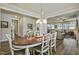 A dining room with wood floors and views into the living room at 465 Gianna Dr, Clayton, NC 27527