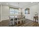 Elegant dining room with hardwood floors, wainscoting, a large window and decorative mirror at 465 Gianna Dr, Clayton, NC 27527