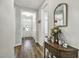 Welcoming entryway with hardwood floors, console table, and decorative mirror at 465 Gianna Dr, Clayton, NC 27527