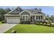 Charming two-story home featuring a well-manicured lawn and a two-car garage at 465 Gianna Dr, Clayton, NC 27527