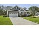 Attractive gray two-story home with well-kept lawn and long driveway at 465 Gianna Dr, Clayton, NC 27527