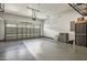 Clean, organized two-car garage featuring epoxy flooring, a new door, and ample storage space at 465 Gianna Dr, Clayton, NC 27527