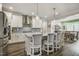 Modern kitchen with white cabinets, stainless appliances, and island seating at 465 Gianna Dr, Clayton, NC 27527