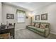 Cozy living room with a green sofa, desk, and carpet flooring, creating a comfortable space at 465 Gianna Dr, Clayton, NC 27527