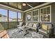 Relaxing screened porch with comfortable seating, outdoor views, and ceiling fan at 465 Gianna Dr, Clayton, NC 27527