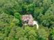 An aerial view reveals a home nestled among lush trees and beautifully landscaped grounds at 4905 Ivercroft Pl, Fuquay Varina, NC 27526