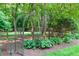 An iron trellis and meticulous landscaping provides charm and serenity in the backyard at 4905 Ivercroft Pl, Fuquay Varina, NC 27526
