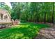 Lush backyard featuring an expansive lawn and a deck with stairs leading to the home at 4905 Ivercroft Pl, Fuquay Varina, NC 27526