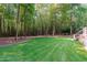 A lush backyard with green grass and surrounding woods offers a serene and private outdoor space at 4905 Ivercroft Pl, Fuquay Varina, NC 27526