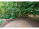 Backyard patio with brick pavers, landscaping and shade trees offers space for outdoor entertaining at 4905 Ivercroft Pl, Fuquay Varina, NC 27526
