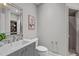 Well-lit bathroom featuring a vanity with a mirror, a toilet, and a glass-enclosed shower for a fresh design at 4905 Ivercroft Pl, Fuquay Varina, NC 27526