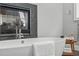 Close up of luxurious bathroom featuring a soaking tub, modern fixtures, and fireplace at 4905 Ivercroft Pl, Fuquay Varina, NC 27526