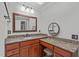 Bathroom vanity with granite countertops, decorative mirror and wooden cabinets at 4905 Ivercroft Pl, Fuquay Varina, NC 27526