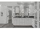 Bright bathroom features a double vanity, walk-in shower, and an entrance to a walk-in closet at 4905 Ivercroft Pl, Fuquay Varina, NC 27526