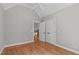 Bedroom with hardwood floors leading to doorway and double door closet at 4905 Ivercroft Pl, Fuquay Varina, NC 27526